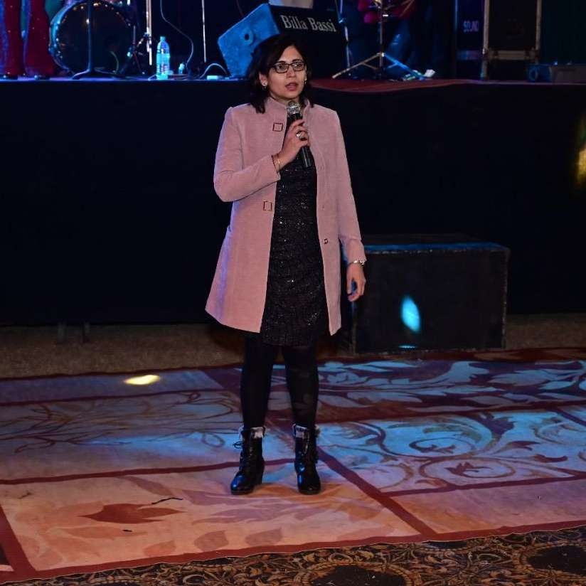 Dr. Simpi Nanda speaking on stage at an event